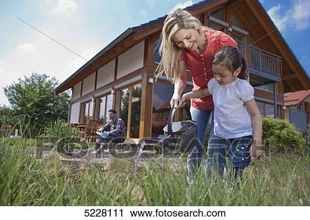 Stock Image - Family in front of Lehner energy house, Poing, Bavaria, Germany, Europe . Fotosearch