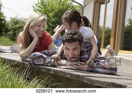 Stock Image - Family in front of Lehner energy house, Poing, Bavaria, Germany, Europe . Fotosearch