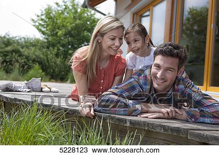 Stock Image - Family in front of Lehner energy house, Poing, Bavaria, Germany, Europe . Fotosearch