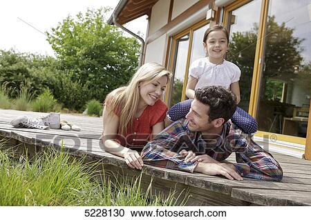 Stock Image - Family in front of Lehner energy house, Poing, Bavaria, Germany, Europe . Fotosearch