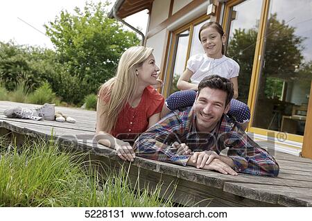 Stock Image - Family in front of Lehner energy house, Poing, Bavaria, Germany, Europe . Fotosearch