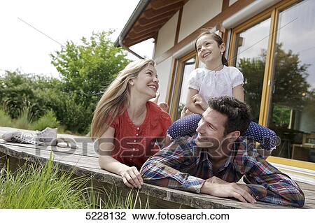 Stock Image - Family in front of Lehner energy house, Poing, Bavaria, Germany, Europe . Fotosearch