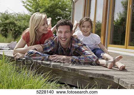 Stock Image - Family in front of Lehner energy house, Poing, Bavaria, Germany, Europe . Fotosearch