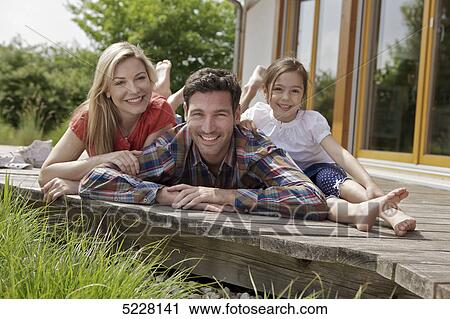Stock Image - Family in front of Lehner energy house, Poing, Bavaria, Germany, Europe . Fotosearch