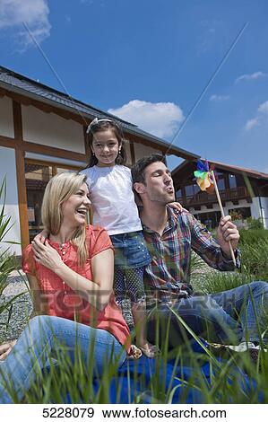 Stock Photo - Family in front of Lehner energy house, Poing, Bavaria, Germany, Europe . Fotosearch