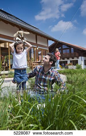 Stock Photo - Family in front of Lehner energy house, Poing, Bavaria, Germany, Europe . Fotosearch