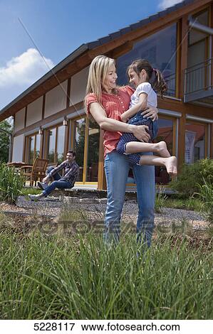 Family in front of Lehner energy house, Poing, Bavaria, Germany, Europe View Large Photo Image Stock Photo - Family in front of Lehner energy house, Poing, Bavaria, Germany, Europe . Fotosearch