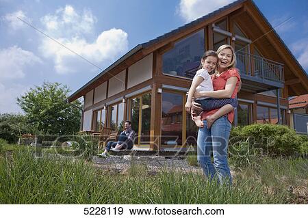 Stock Photo - Family in front of Lehner energy house, Poing, Bavaria, Germany, Europe . Fotosearch