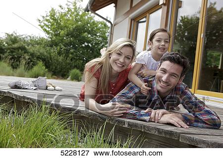 Stock Photo - Family in front of Lehner energy house, Poing, Bavaria, Germany, Europe . Fotosearch