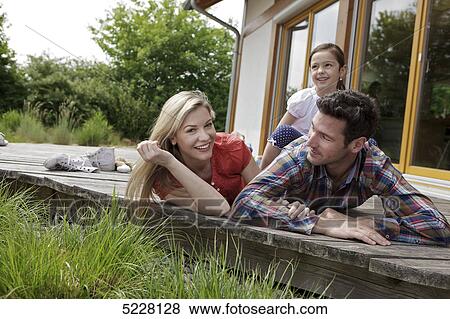 Stock Photo - Family in front of Lehner energy house, Poing, Bavaria, Germany, Europe . Fotosearch
