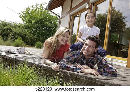 Stock Photo - Family in front of Lehner energy house, Poing, Bavaria, Germany, Europe . Fotosearch