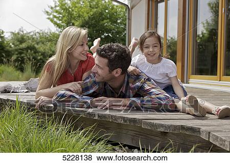 Stock Photo - Family in front of Lehner energy house, Poing, Bavaria, Germany, Europe . Fotosearch