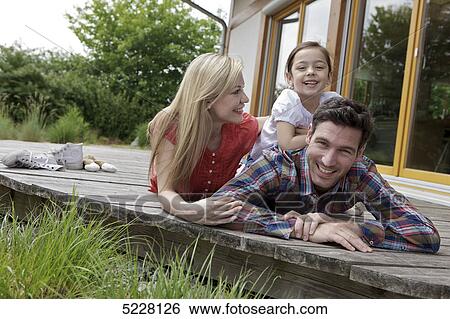 Stock Photograph - Family in front of Lehner energy house, Poing, Bavaria, Germany, Europe . Fotosearch
