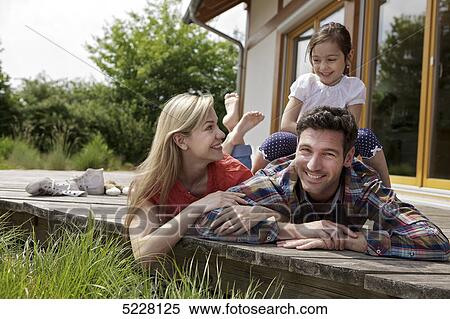 Stock Photography - Family in front of Lehner energy house, Poing, Bavaria, Germany, Europe . Fotosearch