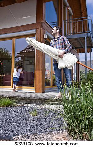 Stock Photo - Father with daughter in front of Lehner energy house, Poing, Bavaria, Germany, Europe . Fotosearch