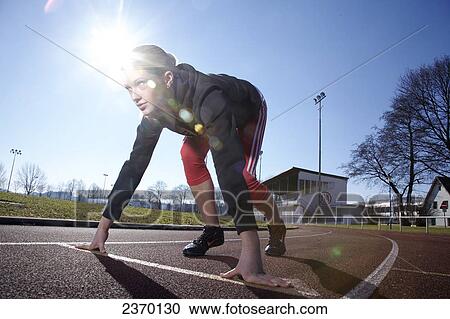 Female athletic in starting position, full length View Large Photo Image Stock Image - Female athletic in starting position, full length . Fotosearch