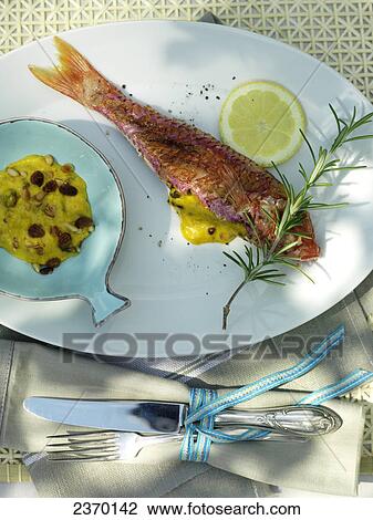 Fish and slice of lemon with savory sauce on plate View Large Photo Image Stock Image - Fish and slice of lemon with savory sauce on plate . Fotosearch