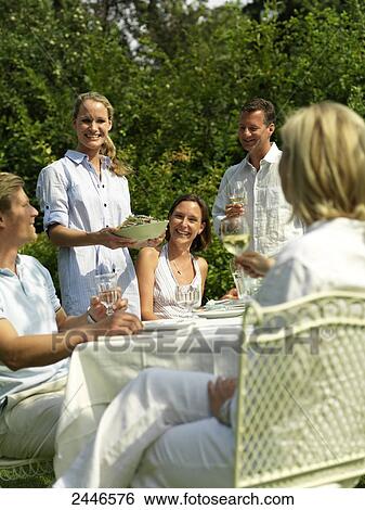 Five people celebrating at a garden party View Large Photo Image Stock Photograph - Five people celebrating at a garden party . Fotosearch