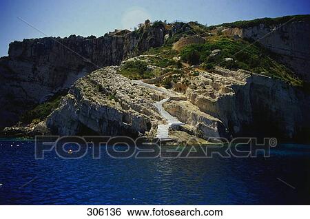 Footpath at coast on rocky cliff, Zakynthos, The Ionian Islands, Greece View Large Photo Image Stock Photograph - Footpath at coast on rocky cliff, Zakynthos, The Ionian Islands, Greece . Fotosearch