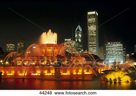 Stock Photo - Fountain and building lit up at night, Buckingham Fountain, Aon Building, Amoco Building, Chicago, Illinois, USA . Fotosearch