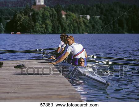 Four rowers near pier in lake View Large Photo Image Stock Image - Four rowers near pier in lake . Fotosearch