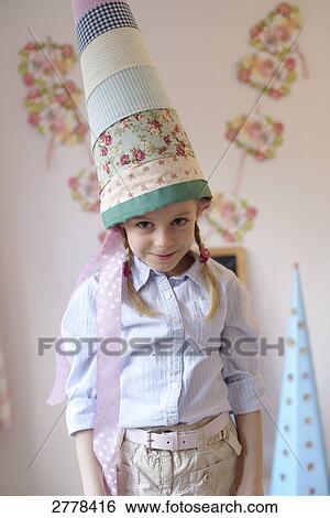 Stock Photograph - girl with a cardbone cone, portrait . Fotosearch