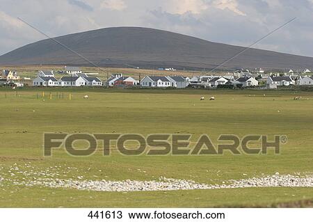 Stock Image - Golf course in front of houses on rural landscape, Achill Island, Republic of Ireland . Fotosearch