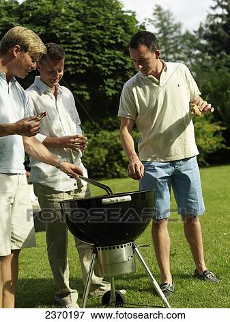 Group of men having barbecue View Large Photo Image Stock Photo - Group of men having barbecue . Fotosearch