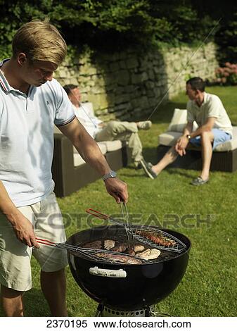 Stock Photography - Group of men having barbecue . Fotosearch