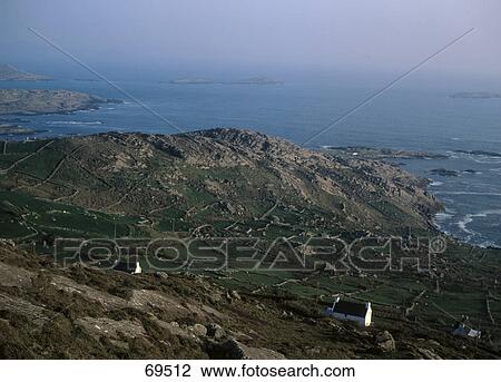 Stock Image - High angle view of coastline at dusk, Ring Of Kerry, Iveragh Peninsula, County Kerry, Republic Of Ireland . Fotosearch