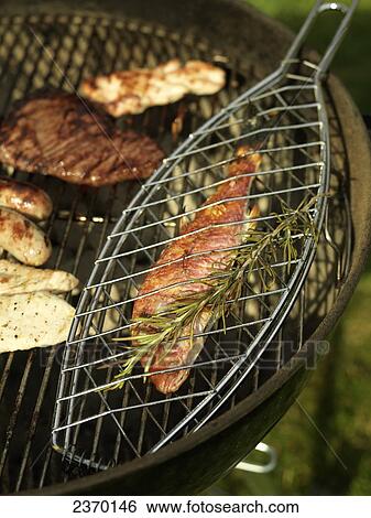 High angle view of fish and sausages on barbecue grill View Large Photo Image Stock Photograph - High angle view of fish and sausages on barbecue grill . Fotosearch