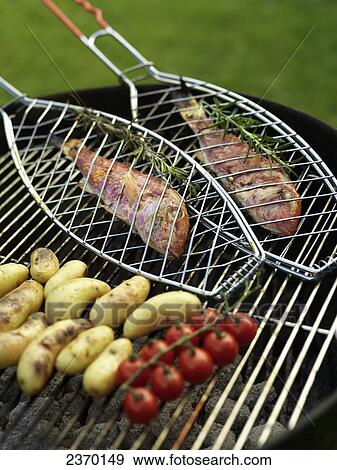 High angle view of fish and sausages with cherry tomatoes on barbecue grill View Large Photo Image Stock Photo - High angle view of fish and sausages with cherry tomatoes on barbecue grill . Fotosearch