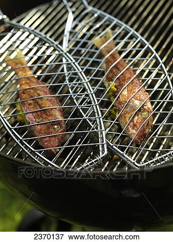 High angle view of fish on barbecue grill View Large Photo Image Stock Photo - High angle view of fish on barbecue grill . Fotosearch