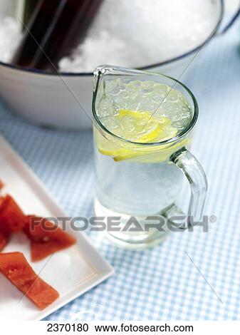 Stock Image - High angle view of pitcher of lemonade . Fotosearch