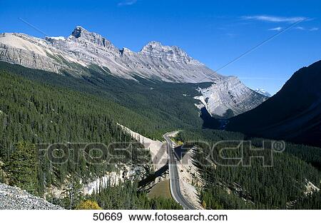 Stock Photo - High angle view of road passing through mountain, Icefields Parkway, Alberta, Canada . Fotosearch