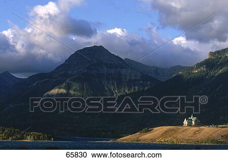 Stock Image - Hotel on hilltop at lakeside, Prince Of Wales Hotel, Waterton Lake, Waterton Lakes National Park, Canada . Fotosearch