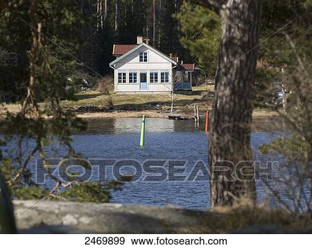 Stock Photo - House at lakeside, Lake Vaenern, Kristinehamn, Varmland County, Sweden . Fotosearch