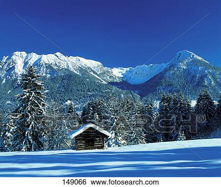 Stock Photograph - Hut in snow covering landscape, Karwendel Mountains, Bavaria, Germany . Fotosearch