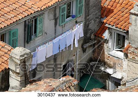 Stock Photo - Inner yard with laundry line in front of exterior wall, Split, Croatia, elevated view . Fotosearch
