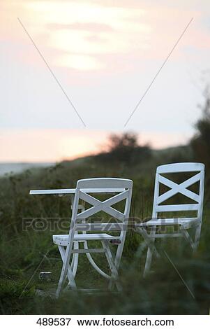 Stock Photo - Lawn chair with table in garden . Fotosearch