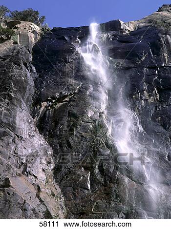 Stock Image - Low angle view of a waterfall, Bridelveil falls, Yosemite national park, California, USA . Fotosearch
