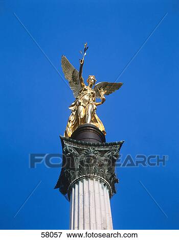 Low angle view of angel of peace statue against blue sky, Munich, Germany View Large Photo Image Stock Photo - Low angle view of angel of peace statue against blue sky, Munich, Germany . Fotosearch