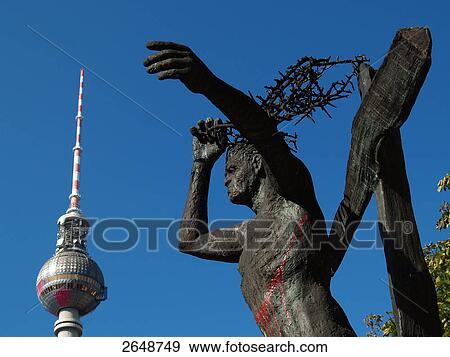 Low angle view of bronze statue with TV tower in background, Alexanderplatz, Berlin, Germany View Large Photo Image Stock Photo - Low angle view of bronze statue with TV tower in background, Alexanderplatz, Berlin, Germany . Fotosearch