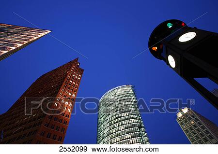 Low angle view of buildings lit up at dusk, Kollhoff Tower, BahnTower, Berlin, Germany View Large Photo Image Stock Photo - Low angle view of buildings lit up at dusk, Kollhoff Tower, BahnTower, Berlin, Germany . Fotosearch