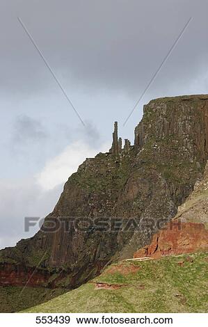Stock Photo - Low angle view of cliff against overcast sky, Giants Causeway, Northern Ireland, UK . Fotosearch