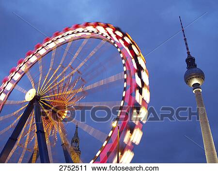 Low angle view of ferries wheel and communication tower against dusky sky View Large Photo Image Stock Image - Low angle view of ferries wheel and communication tower against dusky sky . Fotosearch