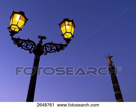 Low angle view of lamp post and column lit up at night View Large Photo Image Stock Image - Low angle view of lamp post and column lit up at night . Fotosearch