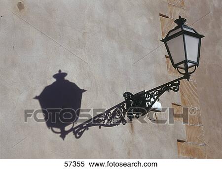 Stock Photography - Low angle view of lantern mounted on wall of church, Majorca, Balearic Islands, Spain . Fotosearch