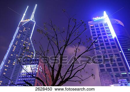 Low angle view of skyscrapers lit up at night, Shimao International Plaza, Shanghai, China View Large Photo Image Stock Image - Low angle view of skyscrapers lit up at night, Shimao International Plaza, Shanghai, China . Fotosearch