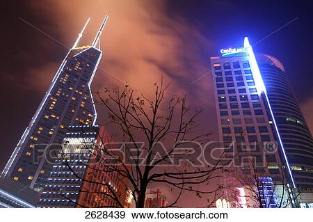 Low angle view of skyscrapers lit up at night, Shimao International Plaza, Shanghai, China View Large Photo Image Stock Photo - Low angle view of skyscrapers lit up at night, Shimao International Plaza, Shanghai, China . Fotosearch
